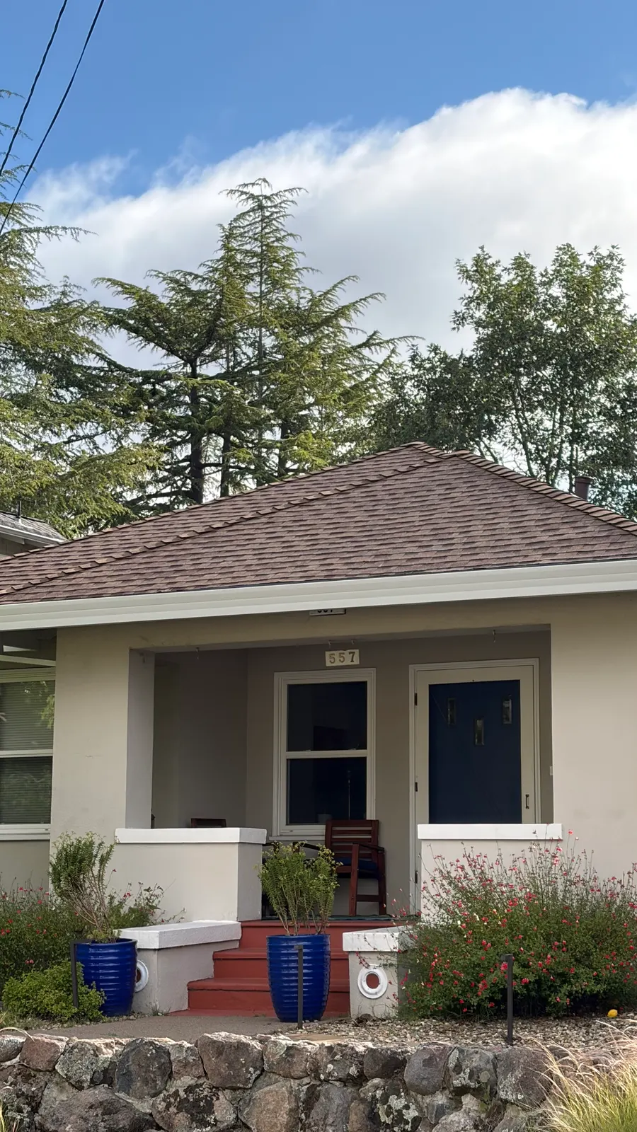 Completed brown shingle roof on a classic bungalow
