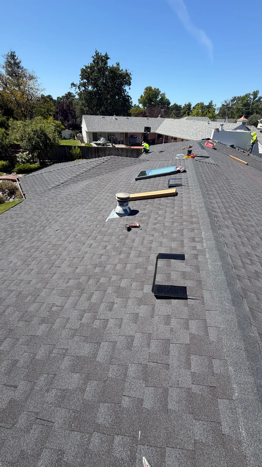 Completed gray shingle roof with properly flashed skylight in Sonoma County