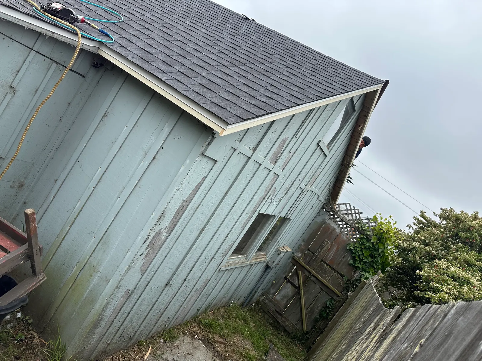 New dark composition shingles on a coastal cottage gable