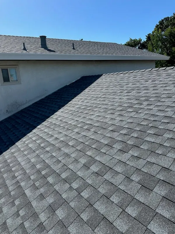Gray composition shingle valley and hip detail on a completed re-roof