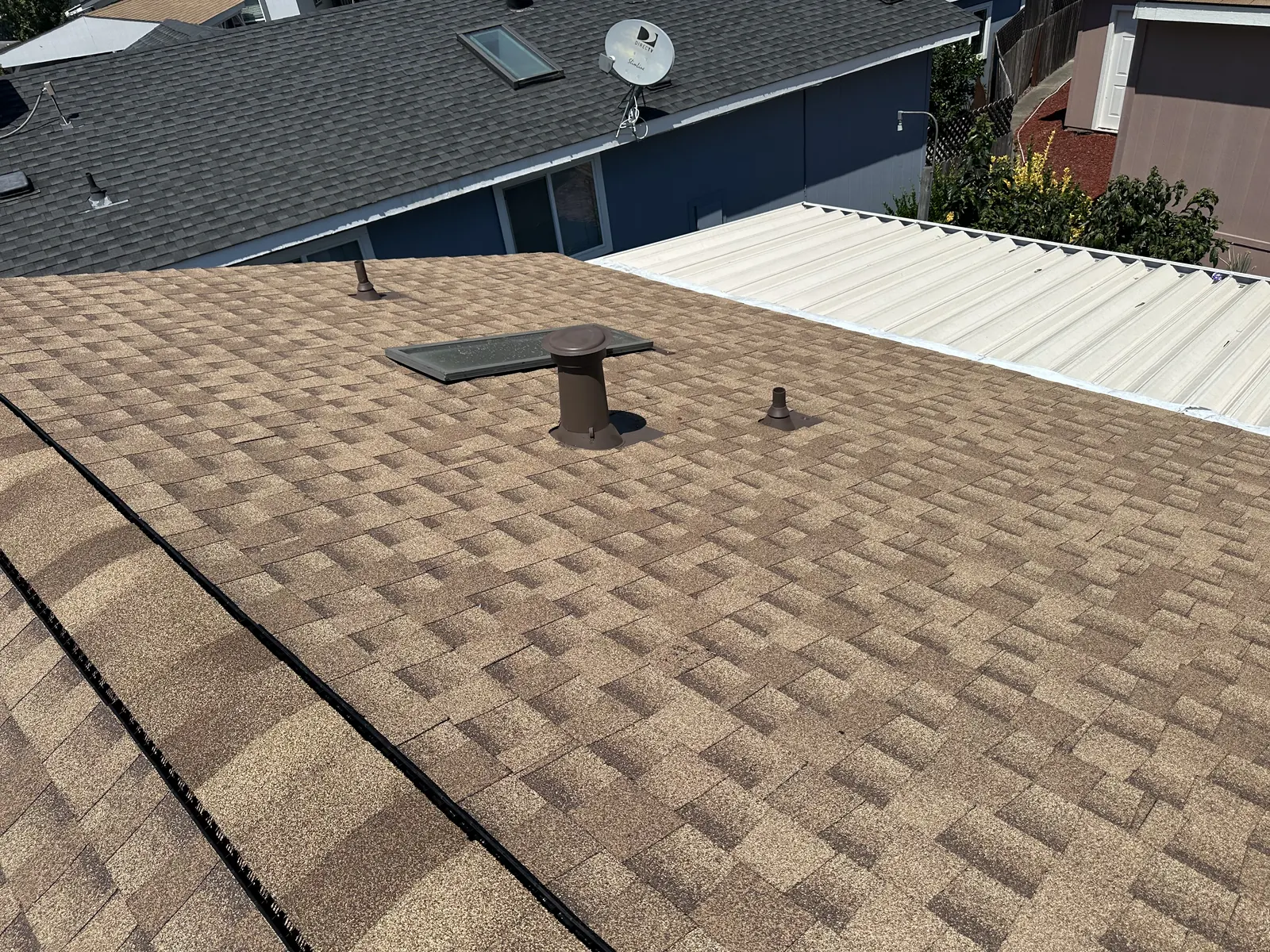 New vent boots and flashing set into a completed shingle roof on a Healdsburg manufactured home
