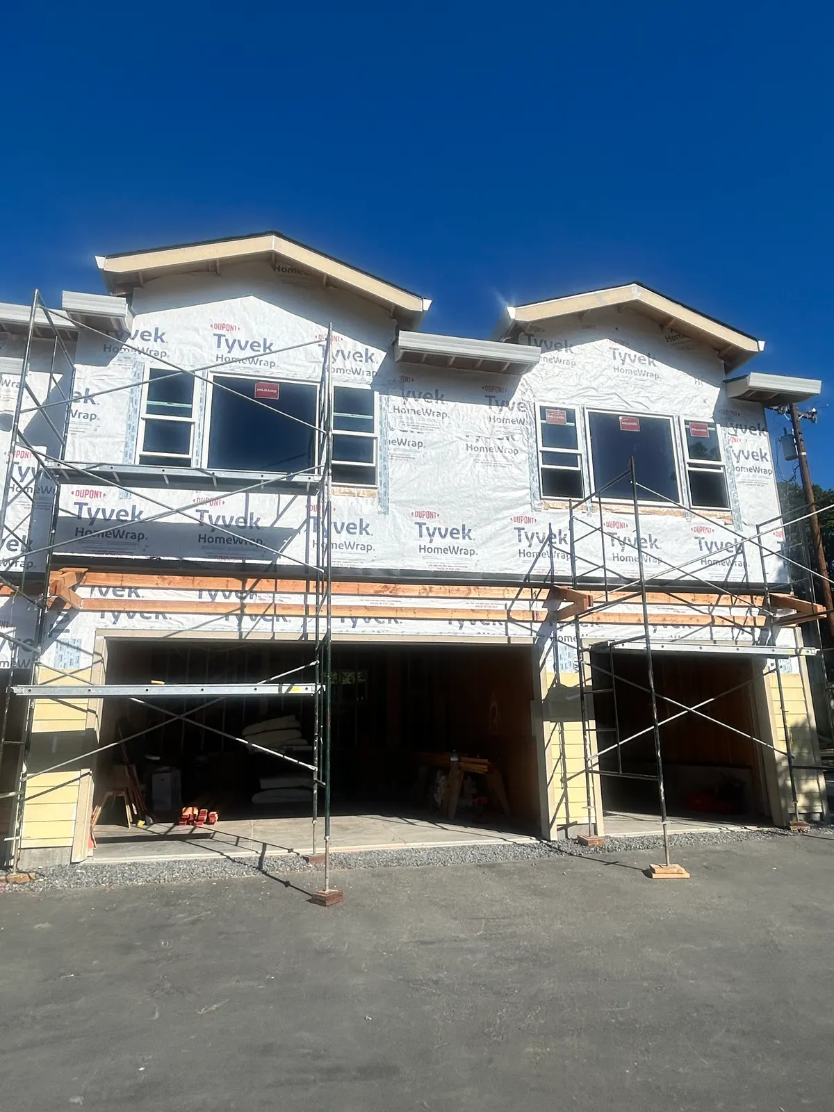 New construction duplex wrapped and scaffolded for roofing