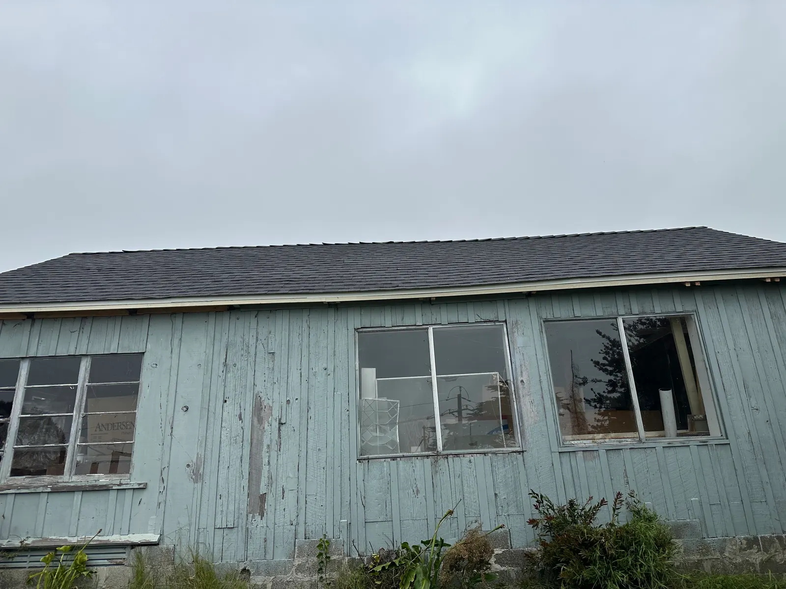 New composition shingle roof on a rural barn outbuilding