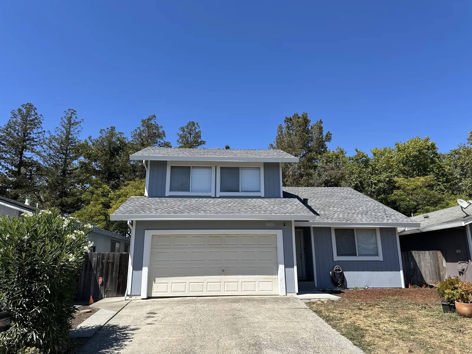 Completed roof replacement on a Rohnert Park two-story home, front elevation with a clean driveway