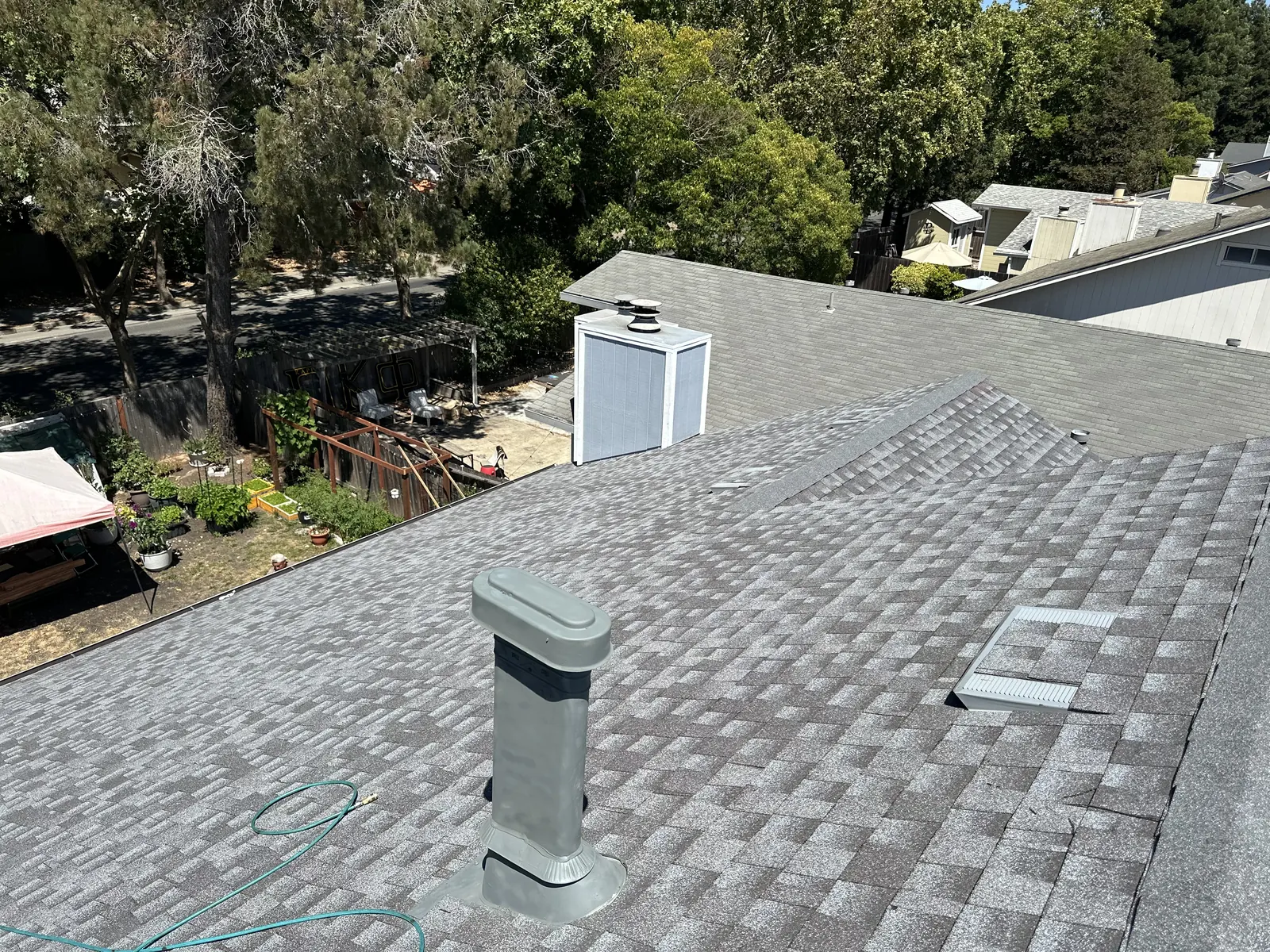 Completed gray architectural shingle roof with a new vent boot and ridge line on a Rohnert Park home