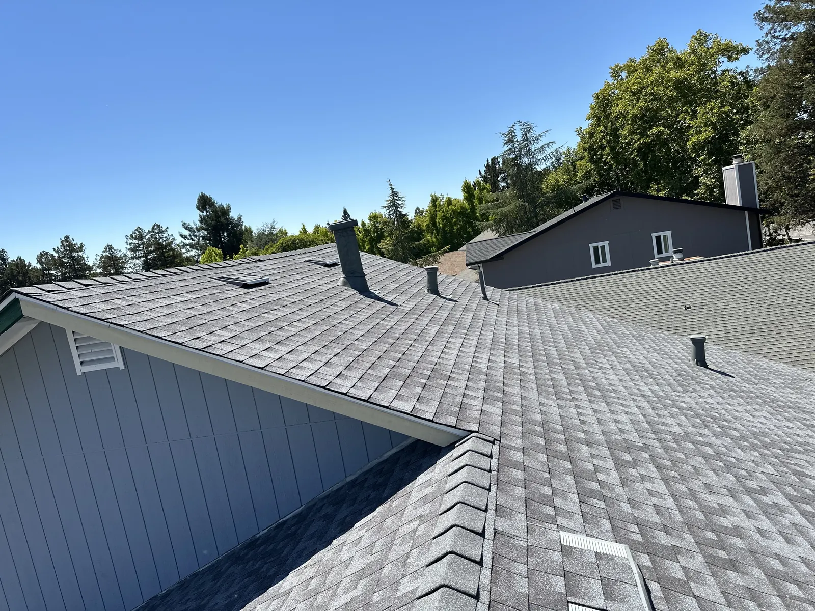 Wide view of a new architectural shingle roof with clean ridge and hip lines in Rohnert Park