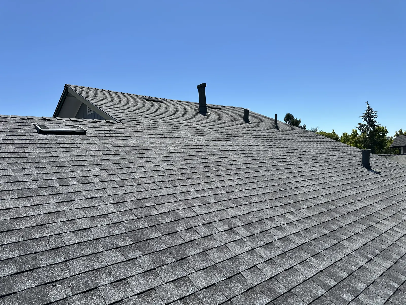 New architectural shingle roof slope with dormer and roof vents on a Rohnert Park home