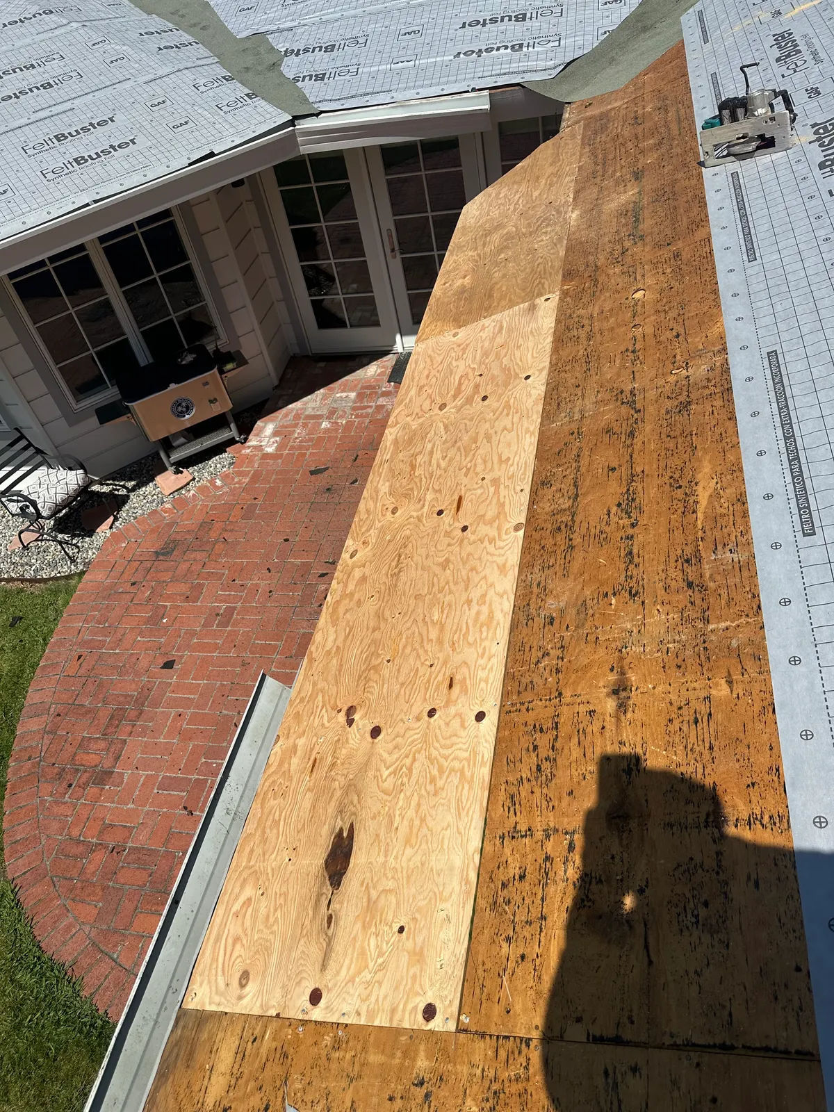 Roof tear-off with fresh plywood re-sheeting over the original deck