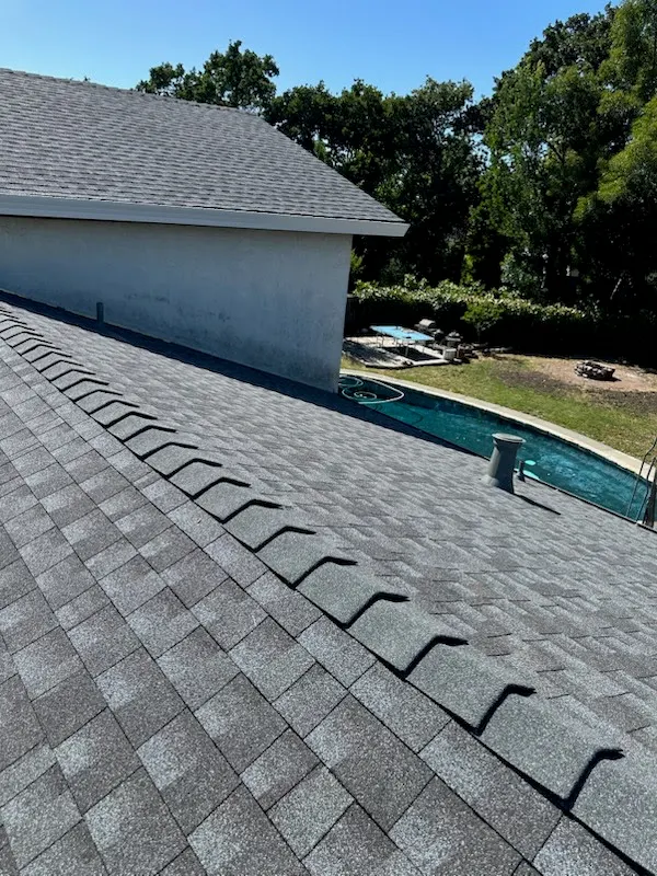 New shingle ridge line above a backyard pool